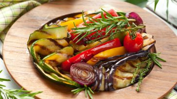 grilled vegetables on a wood plate