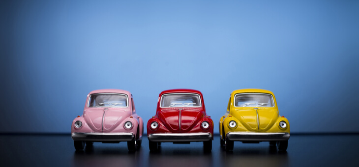 three miniature replicas of volkswagen beetles