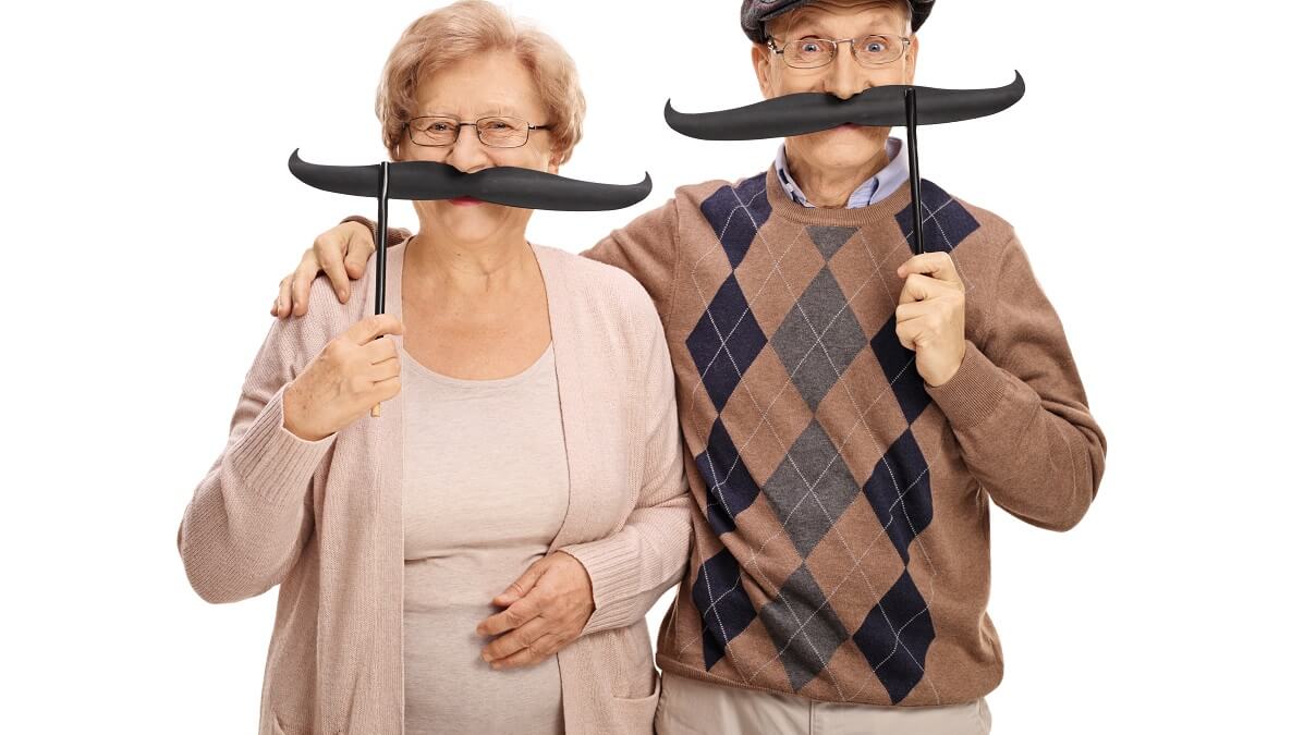 elderly couple with fake moustaches