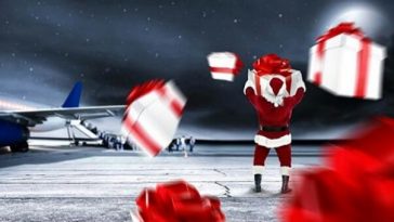 santa claus standing on runway with christmas gifts