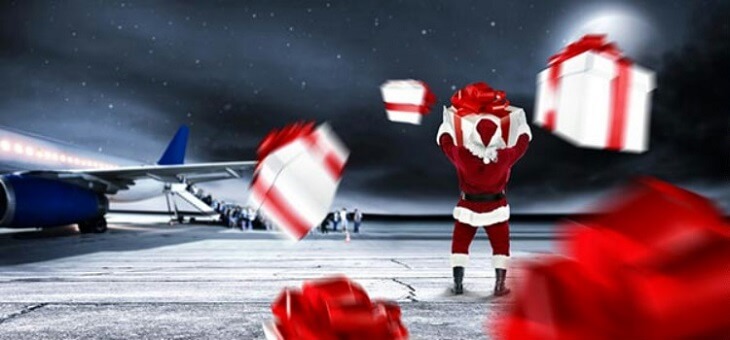 santa claus standing on runway with christmas gifts