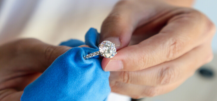 woman polishing diamond ring