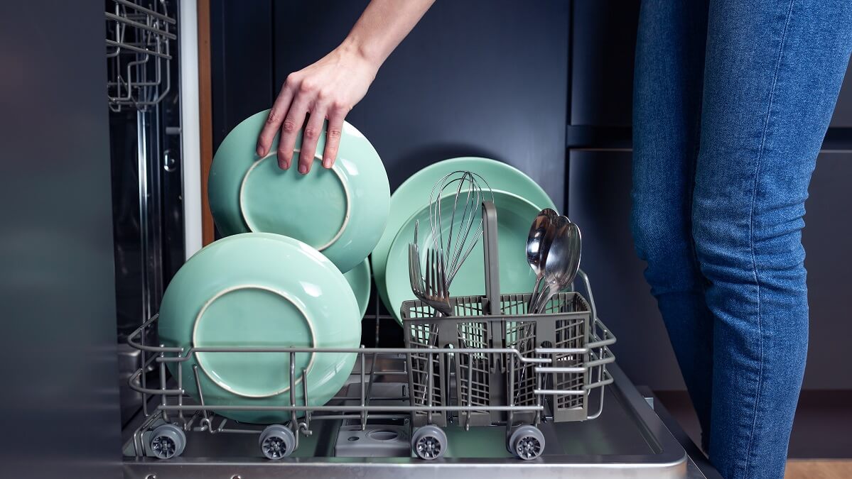 Woman loading a dishwasher