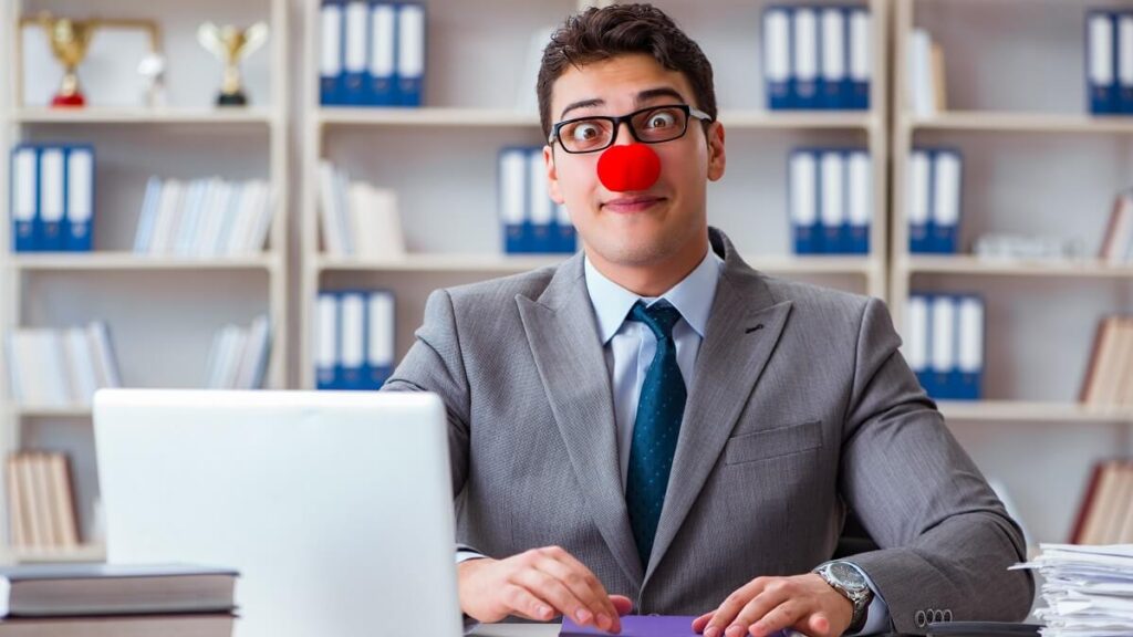 man wearing suit and clown nose in office