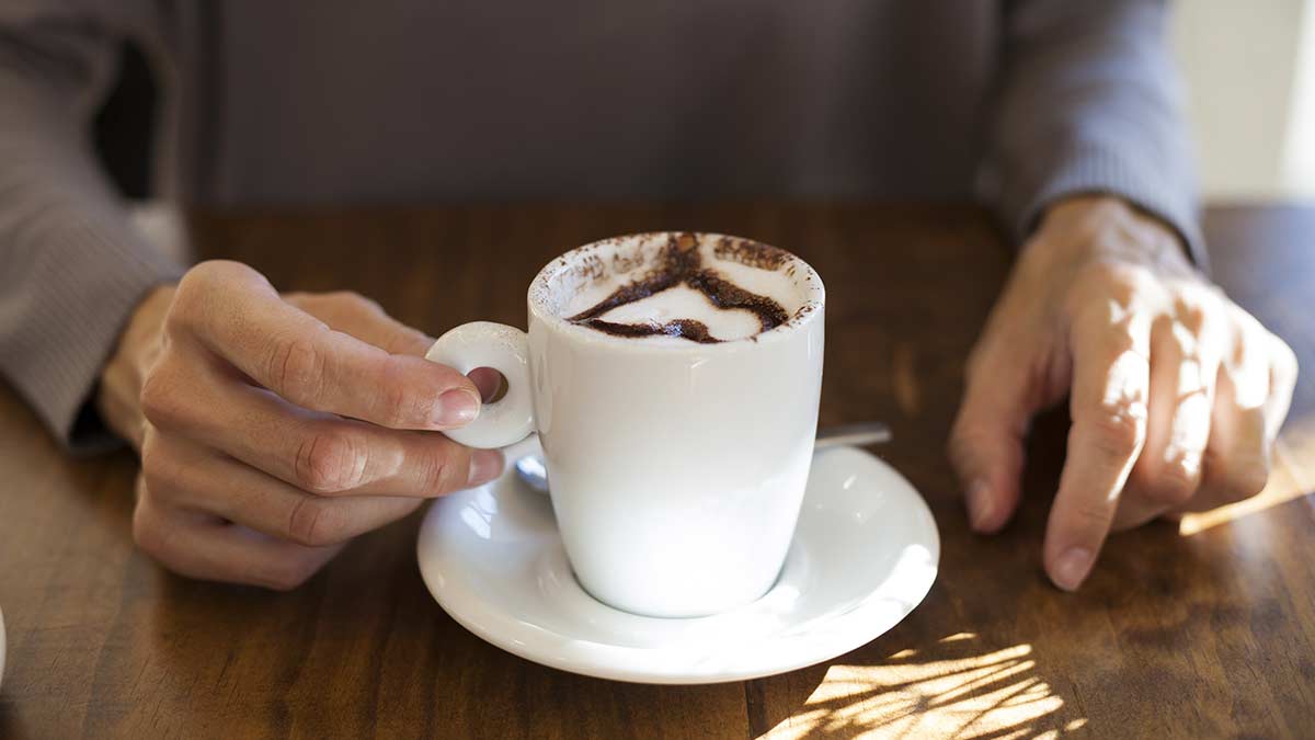 woman drinking cocoa with a chocolate heart