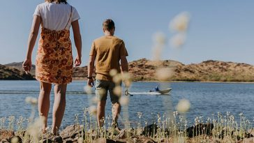 couple walking towards a lake in cloncurry
