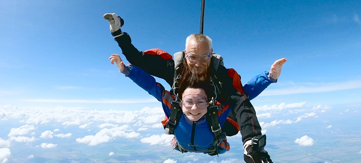 happy couple tandem skydiving