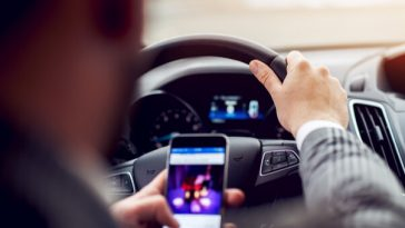 man distracted by phone while driving