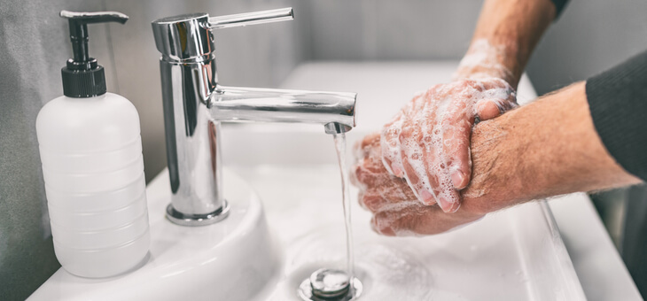 male hands at sink being washed