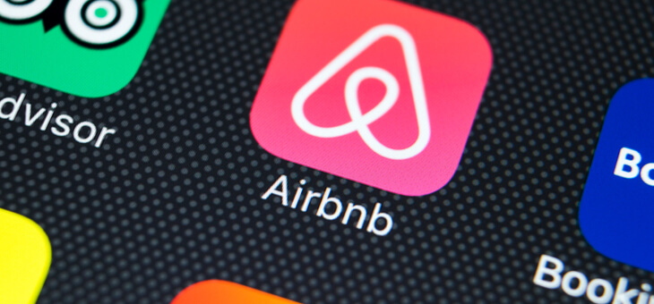 close up of airbnb logo on smartphone screen