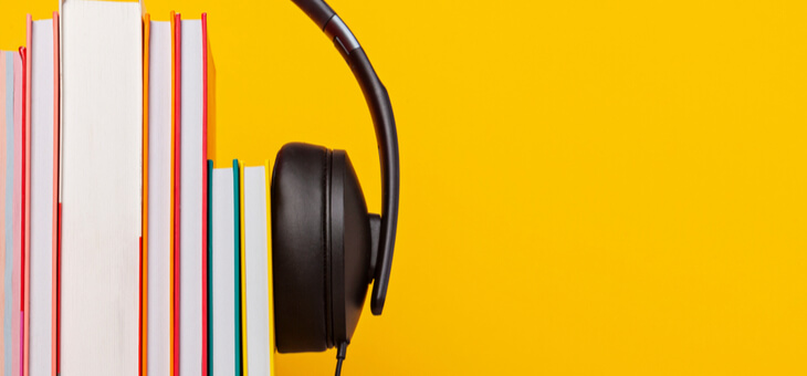stack of books with headphones