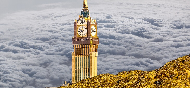 clock tower surrounded by clouds