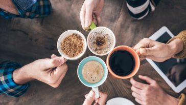 aerial view of four people drinking coffee