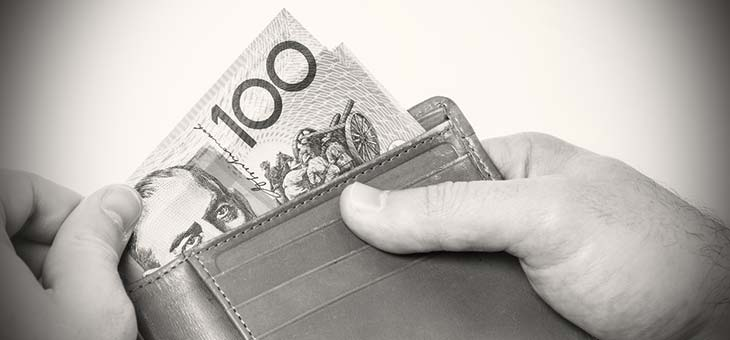 Man holding wallet with Australian money black and white