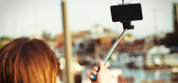 girl with phone on selfie stick