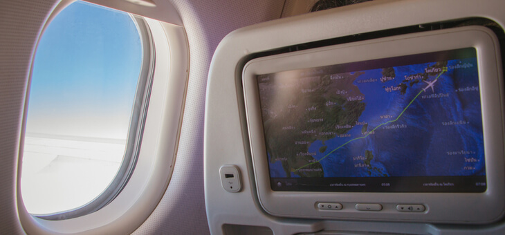 view from airline seat of entertainment screen and out window