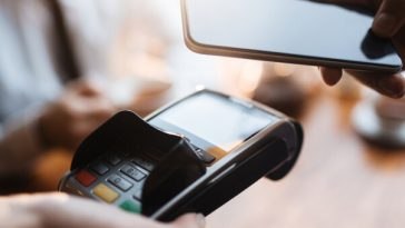 person paying for good with smartphone