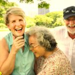 group of older people laughing at the park