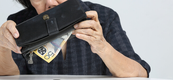 older woman emptying cash from wallet