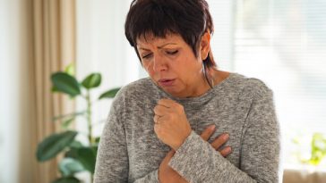 older woman coughing