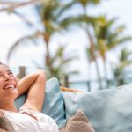 smiling woman lying on lounge in sun
