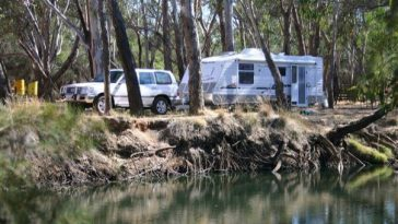 four wheel drive towing caravan in australian bush