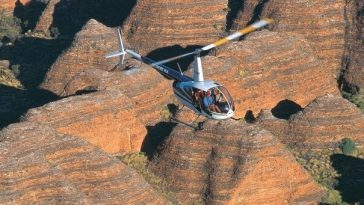 helicopter flying over bungle bungle rock formation