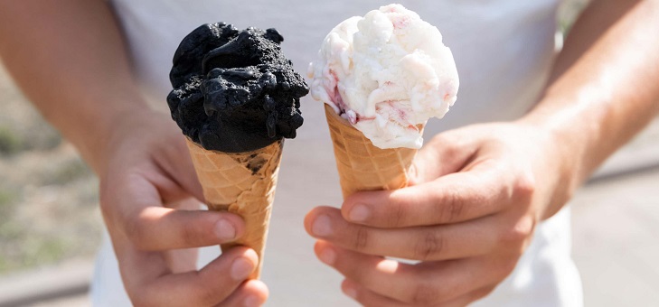 male hands holding chocoalate and vanilla ice cream cones