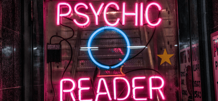 neon sign reading psychic reader