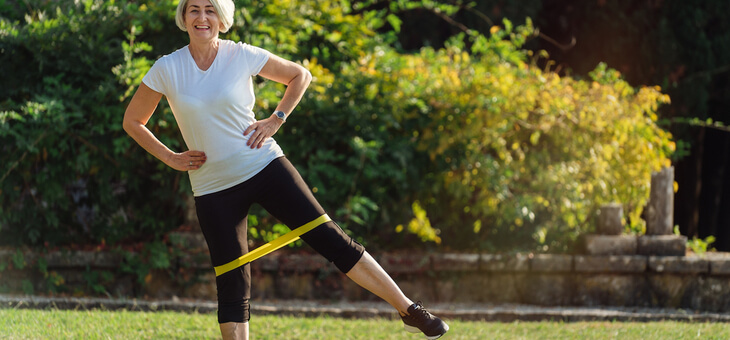 woman stretching legs with resistance band