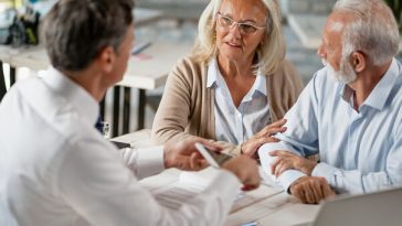 older couple discussing finances with lawyer