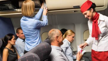 Flight attendant helping passengers
