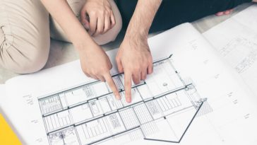 couple examining building plan for house