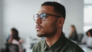 man with glasses looking into distance
