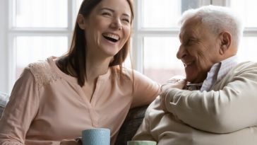 older mand laughing with adult daughter