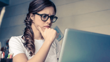 concerned woman looking at laptop screen