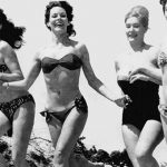 group of women running in different bathing suits