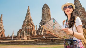 woman holding map at thai temple
