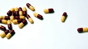 scattered capsules on white background