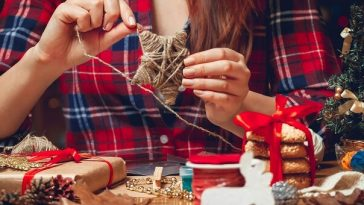woman hand making christmas star from string