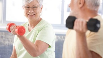 older couple lifting small weights