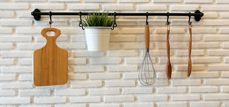 kitchen utensils hung neatly on wall hooks