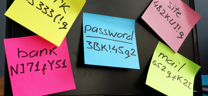 passwords written on sticky notes stuck to computer monitor