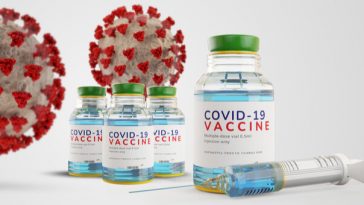vials of covid 19 vaccine with syringe