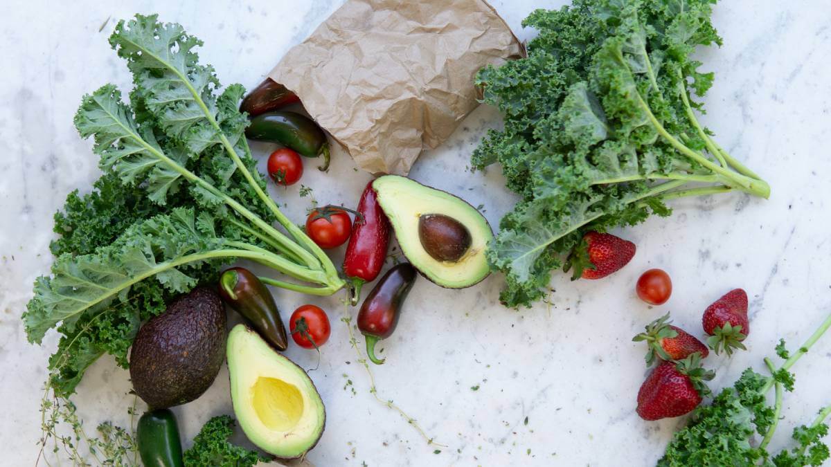 Avocado, kale and other vegetables on a table