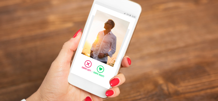 woman looking at man on dating app