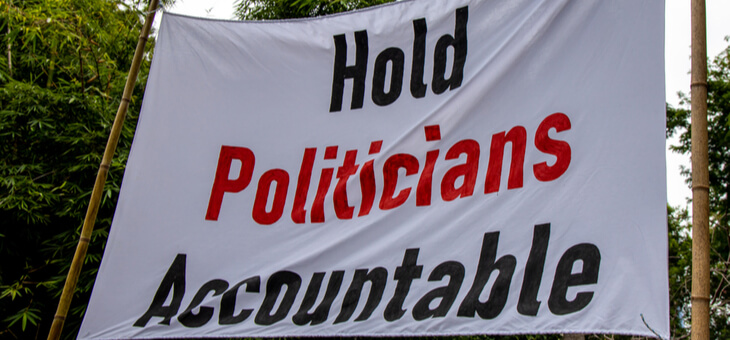 protest sign reading hold politicians accountable