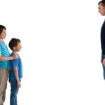 man standing apart from wife and two children