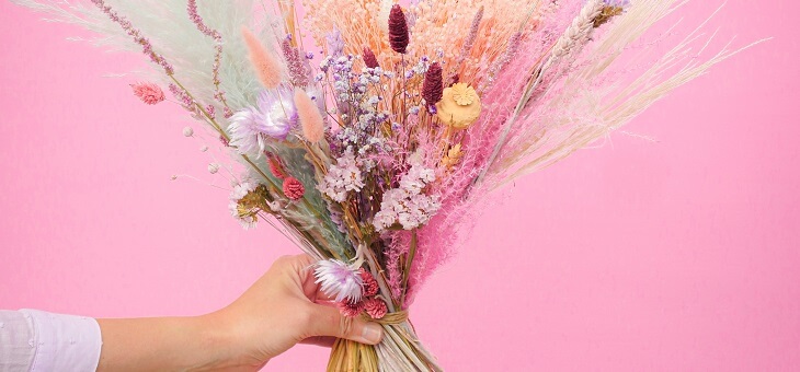 woman's hand holding bouquet of flowers