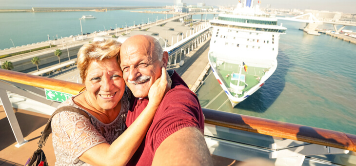 happy mature couple taking selfie on cruise ship